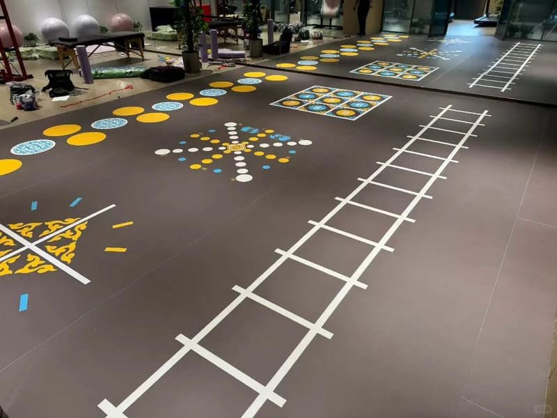 PVC sports flooring backing construction and reinforcement layers
